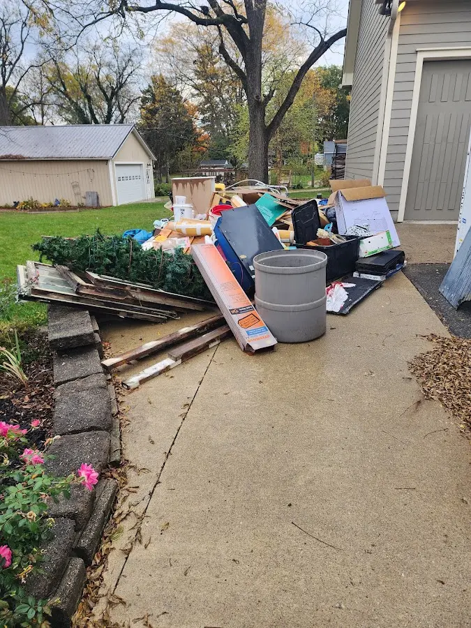 Dumpster being loaded with debris for Roofing Dumpster Rental in Gravette